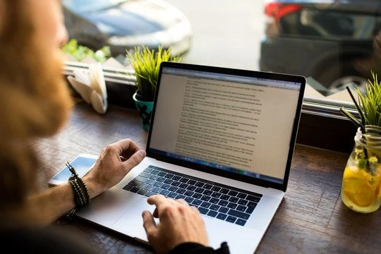 Editor reviewing manuscript with notes